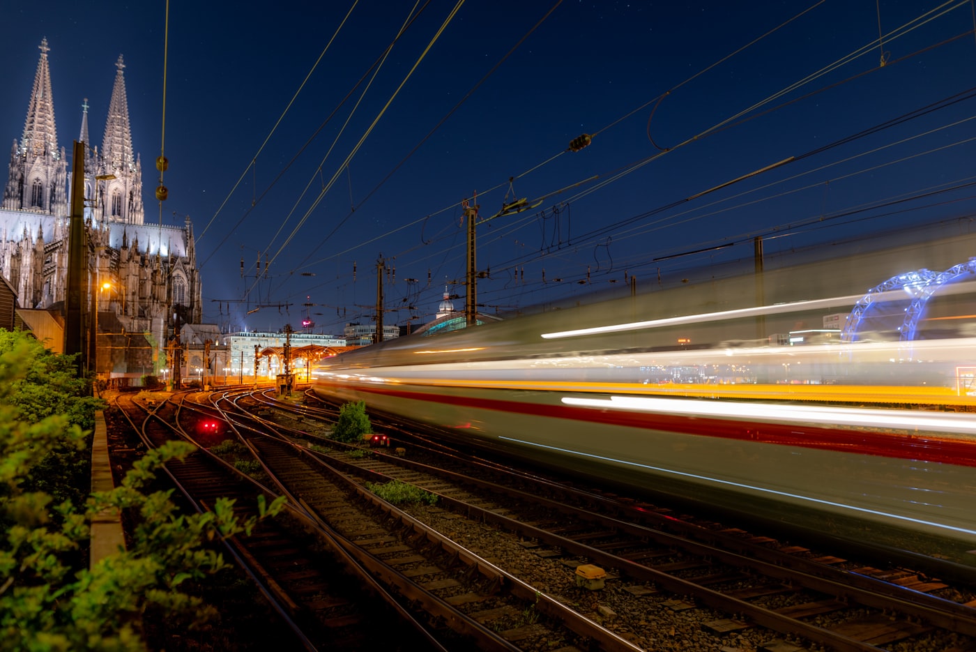 A high-speed train blurring past on railway tracks