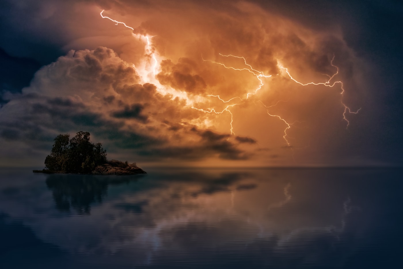 Dramatic lightning strikes over an island and ocean horizon