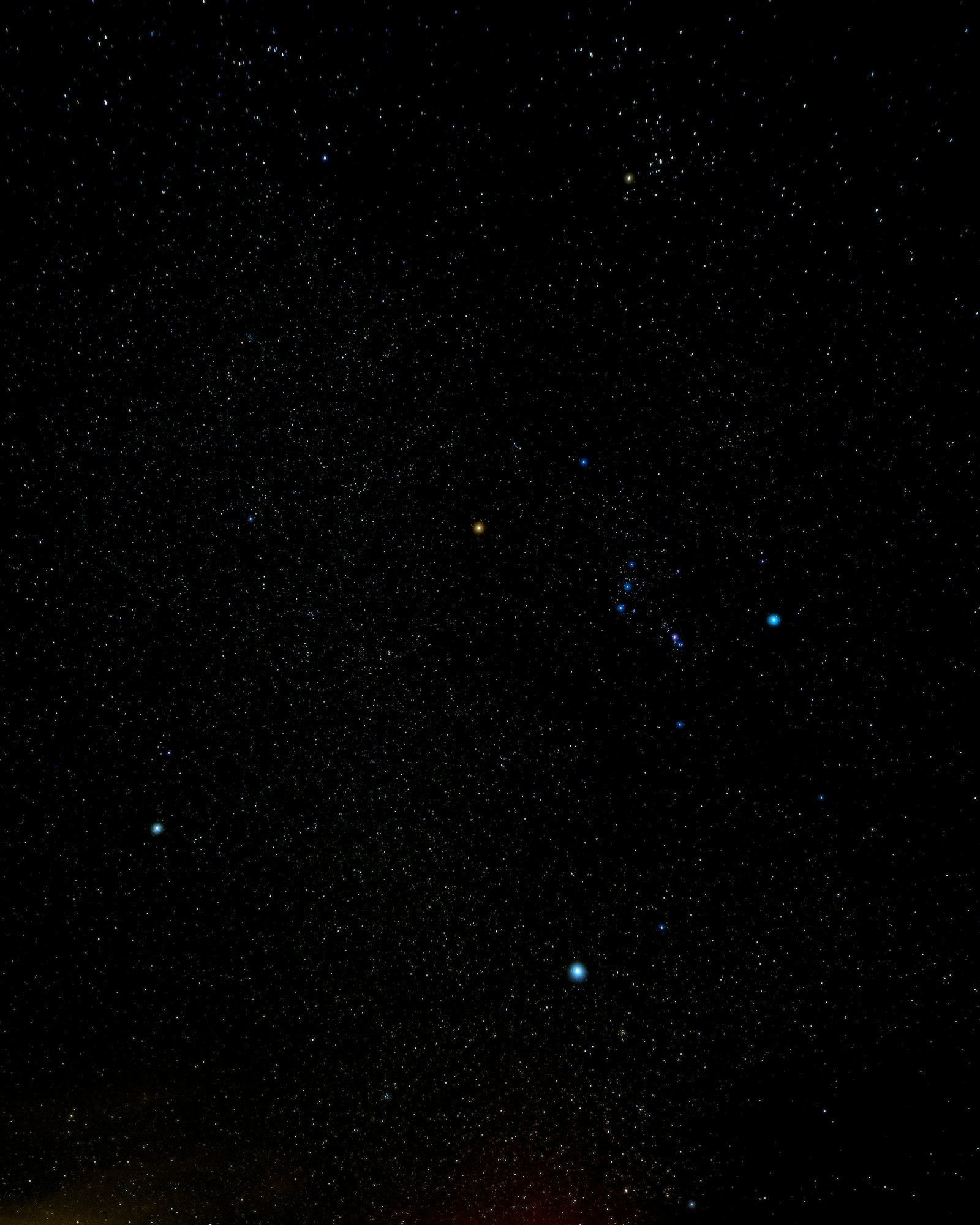 A dense field of stars over Death Valley, with Orion's Belt and the Winter Triangle visible